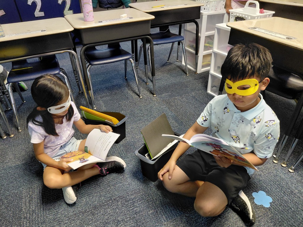 students in masks reading
