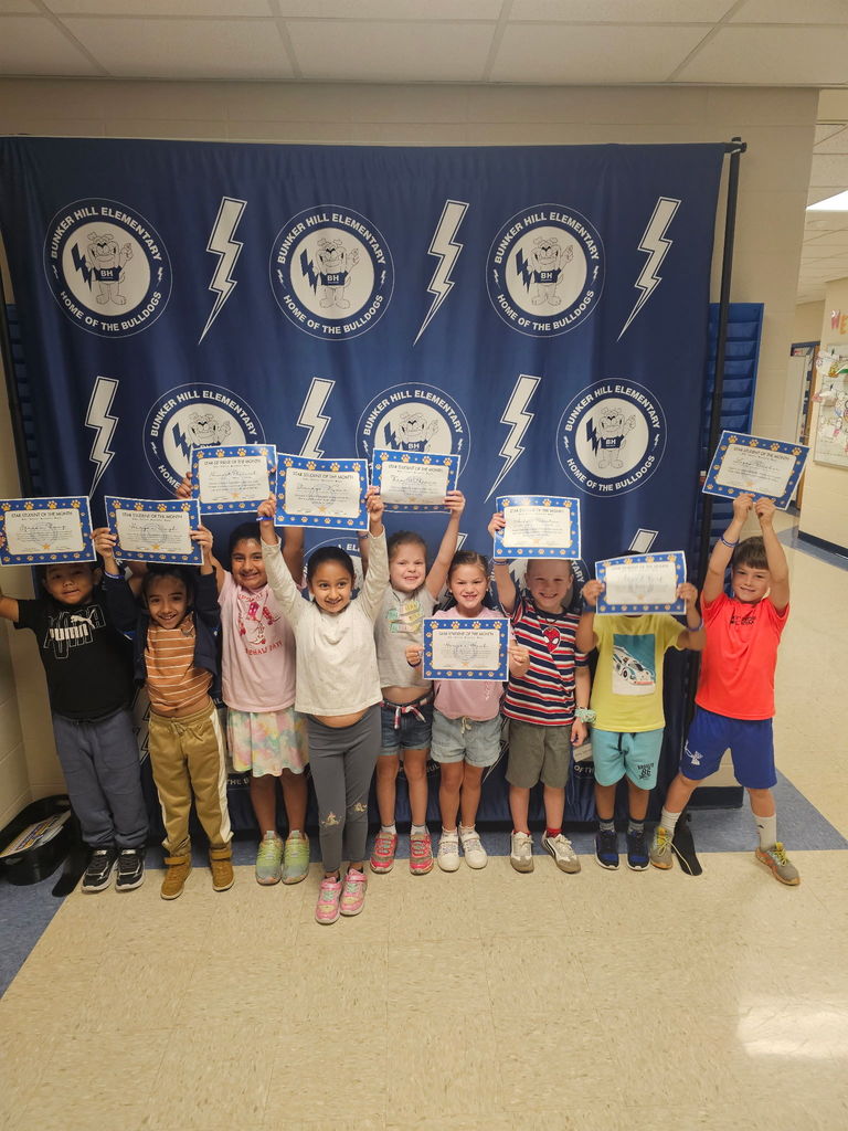First Grade star students with their certificates