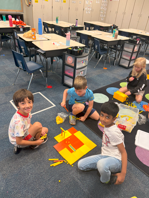 students smiling with number blocks