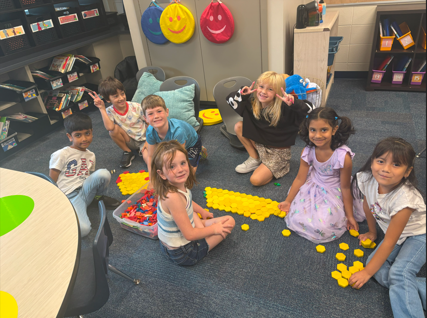 students smiling with geometric shapes