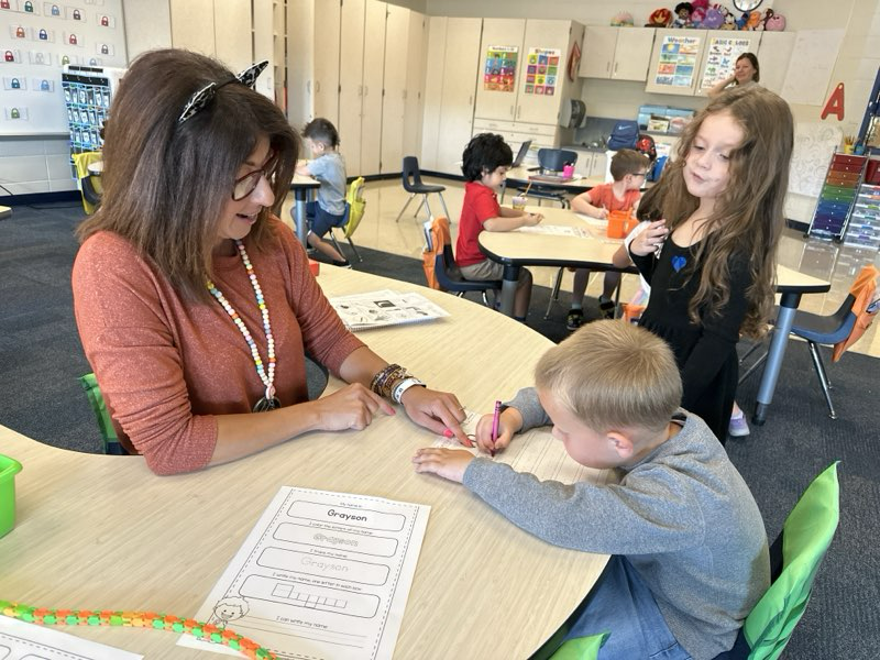 Teacher working with student