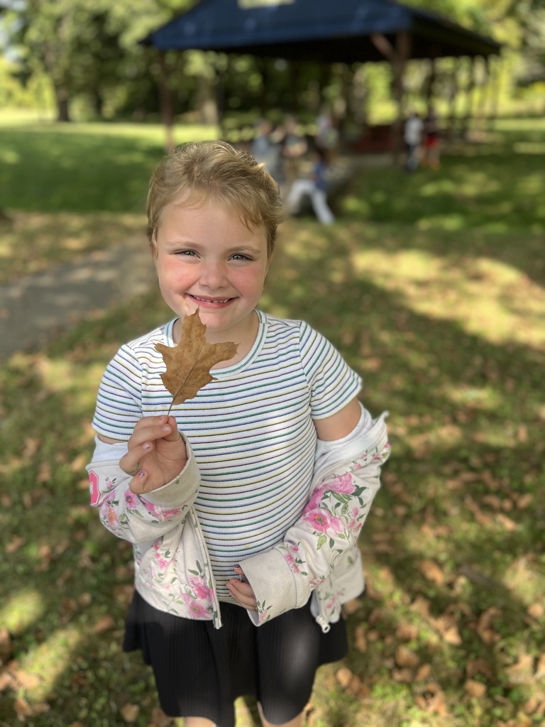 Student holding leaves