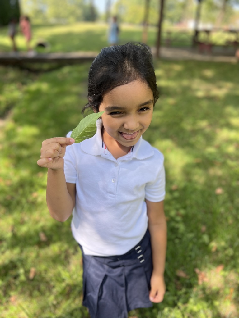 Student holding leaves