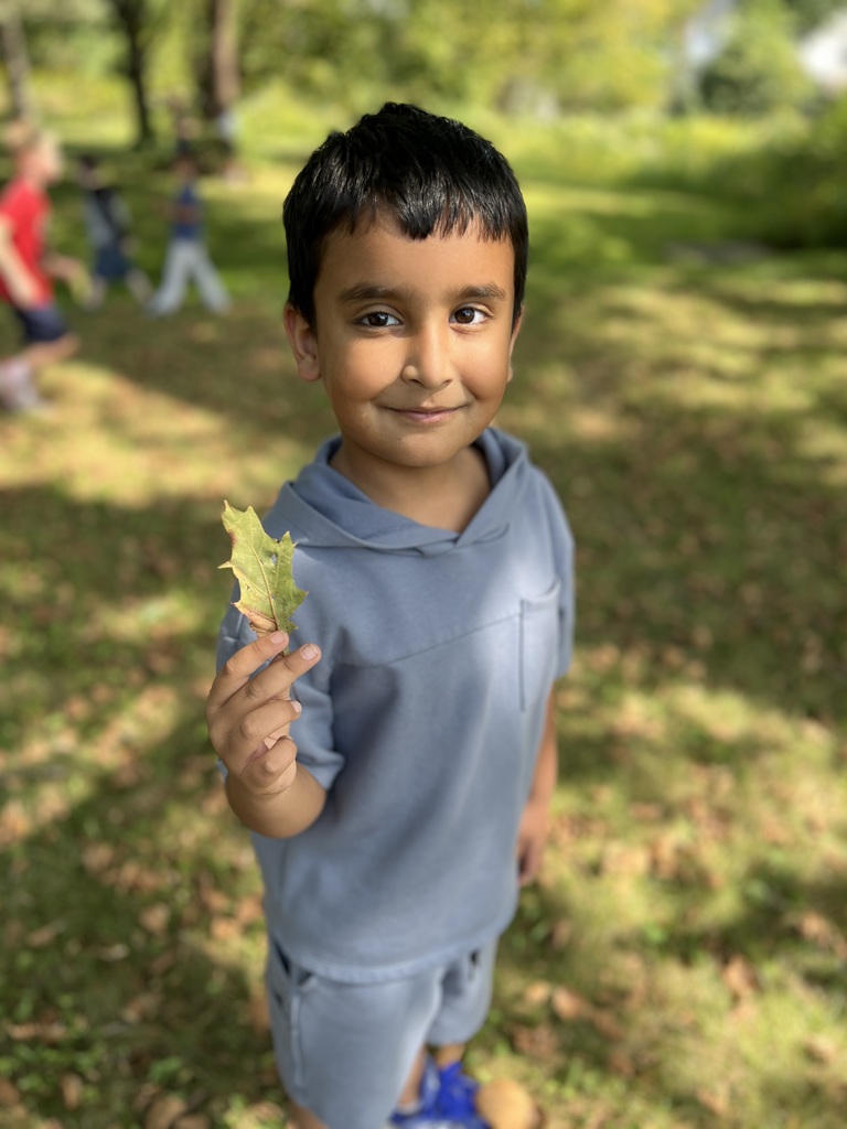 Student holding leaves