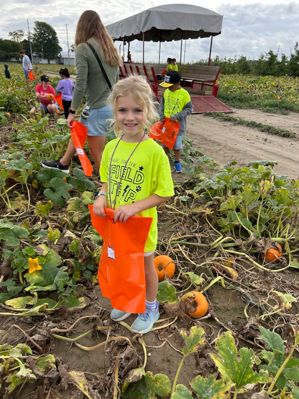 Student smiling in pumpkin patch