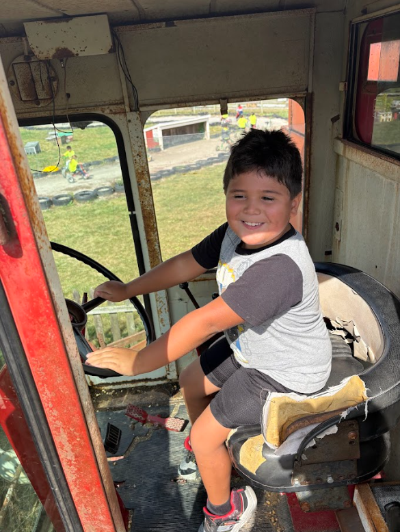 Students smiling in tractor on field trip