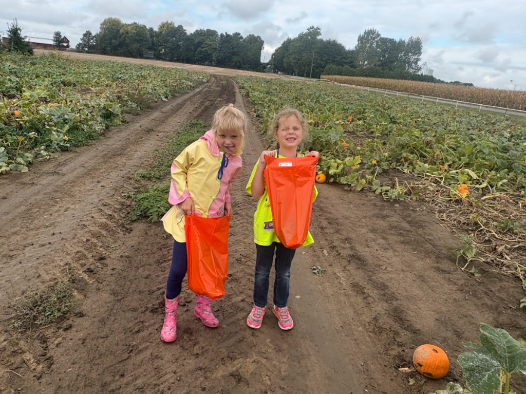 Two students smiling in pumpkin patch