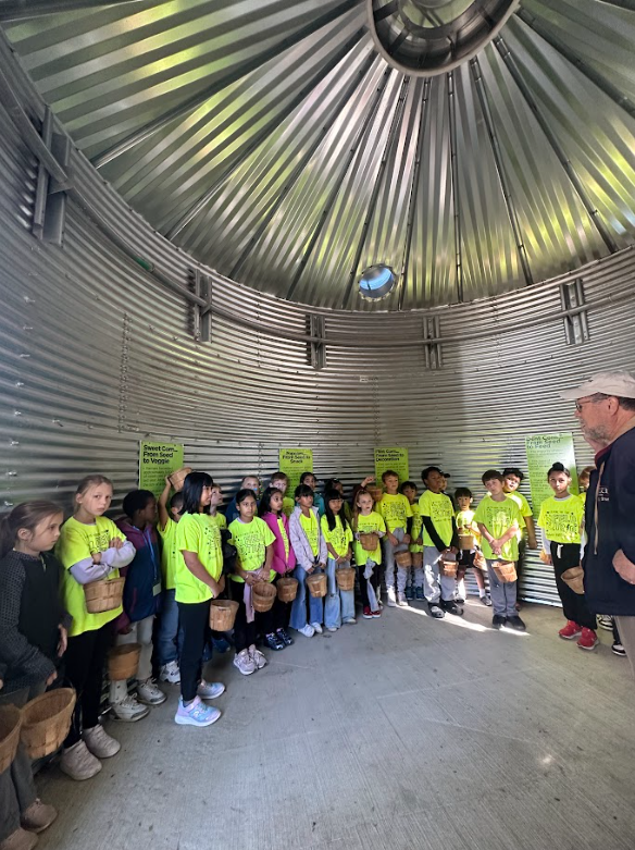 students listening to a speaker on their field trip