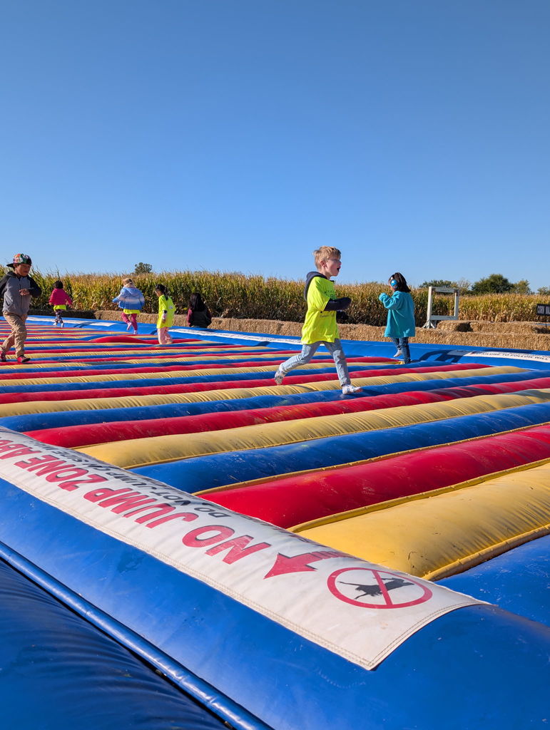kindergarten student running on bounce house