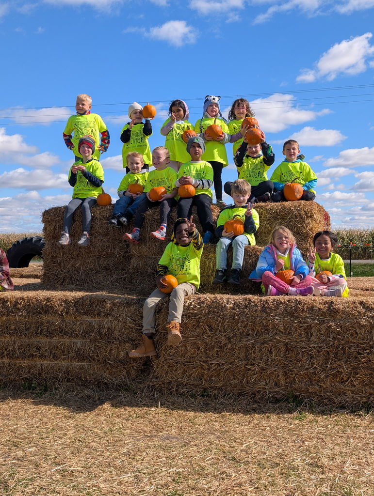 kindergarten class on stacks of hay