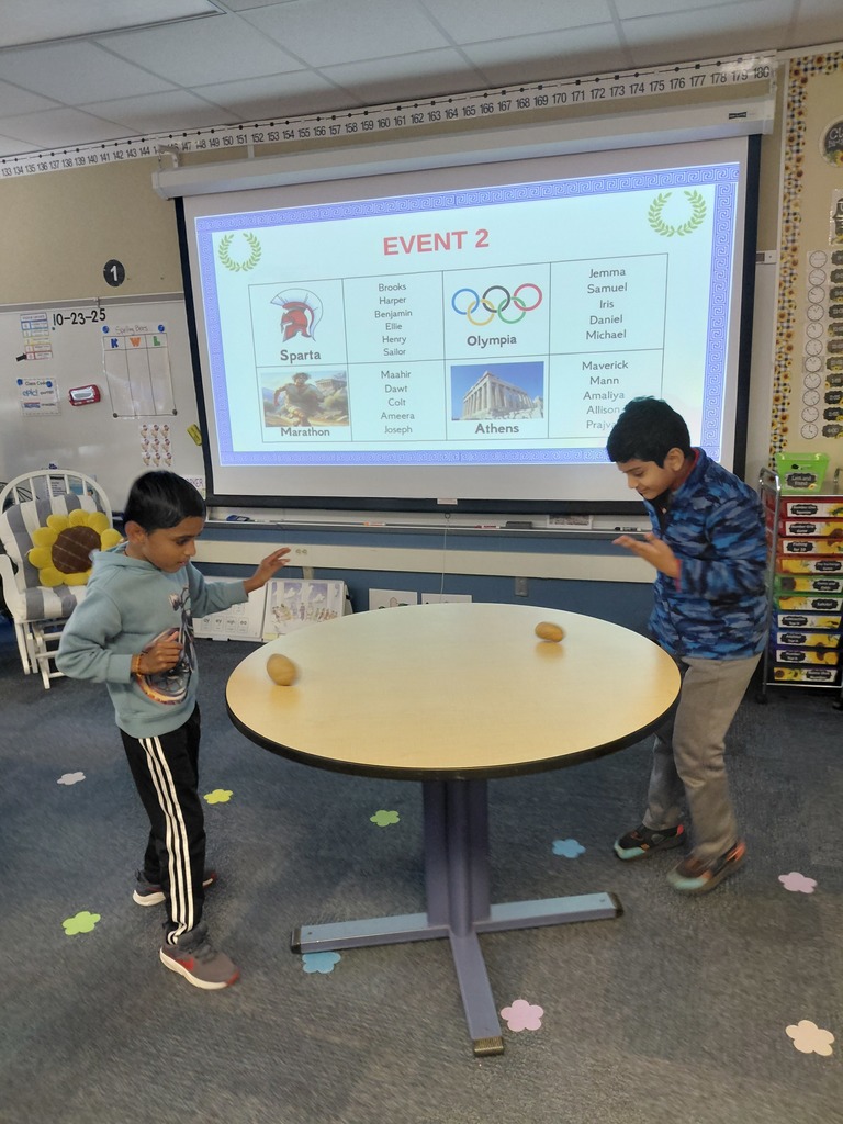 Students holding up potatoes