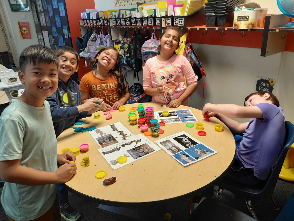 Students holding up potatoes