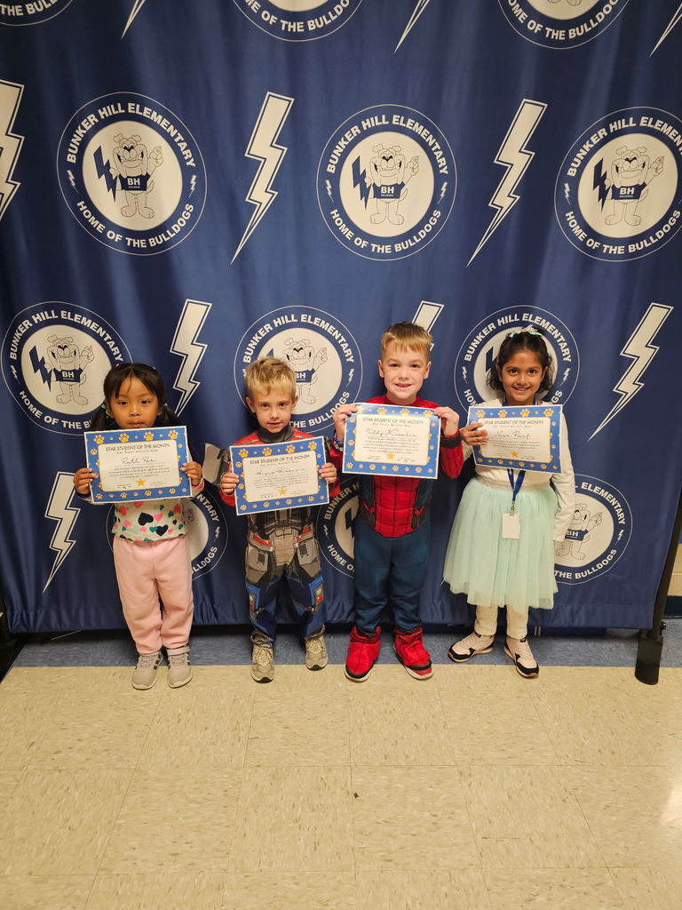 Kindergarten star students smiling with their certificates