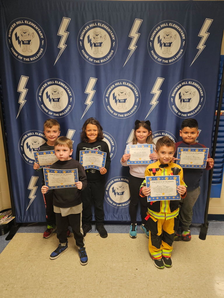 2nd grade students smiling with their certificates