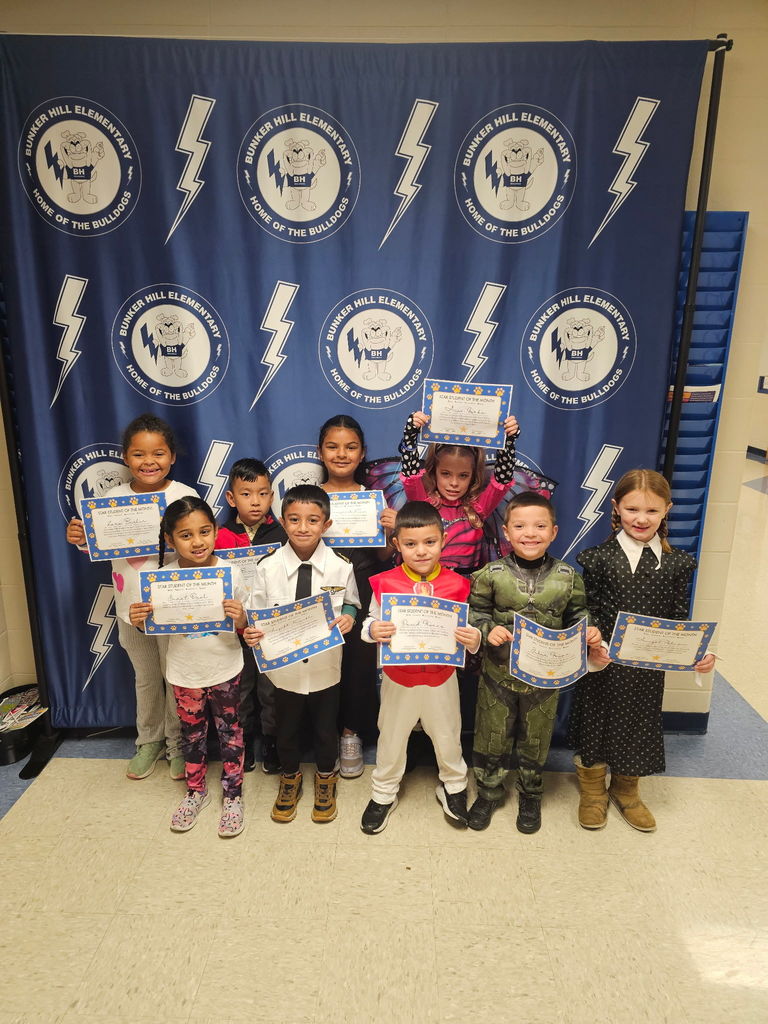 First grade star students smiling with their certificates