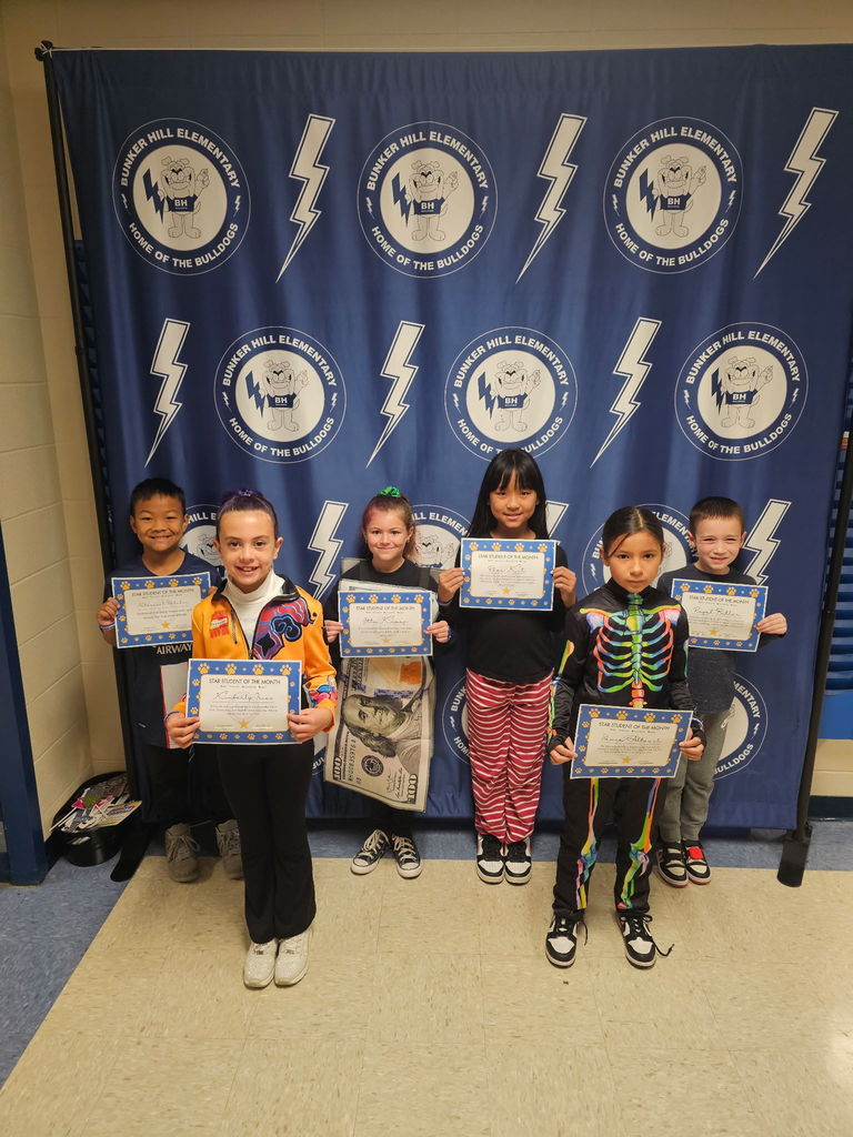 3rd grade students smiling with their certificates