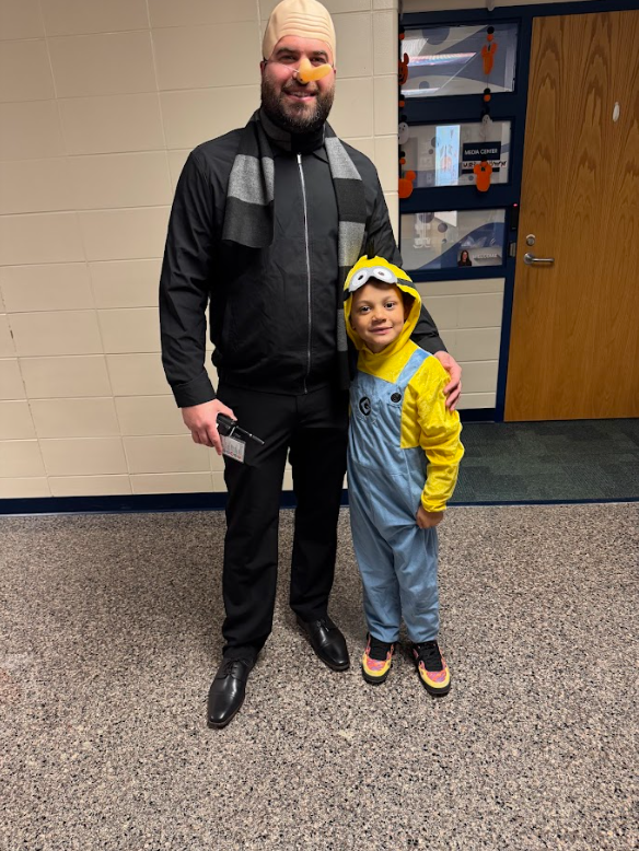 student and picture smiling together as Gru and a Minion