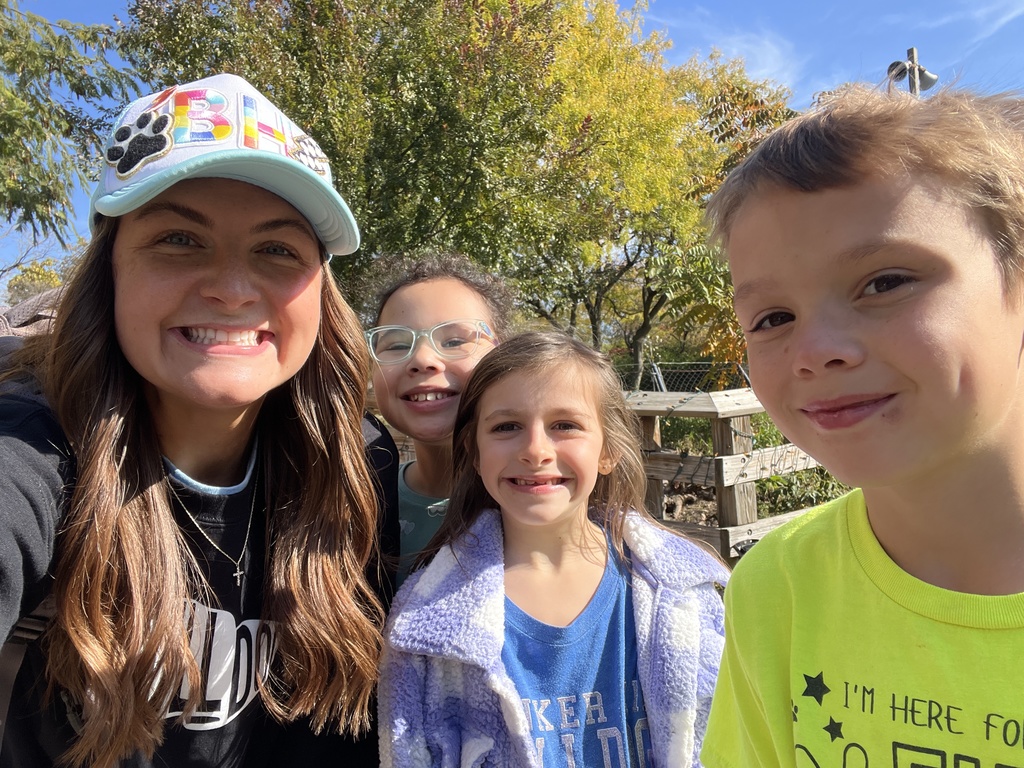 Students smiling with their teacher at the Indy Zoo