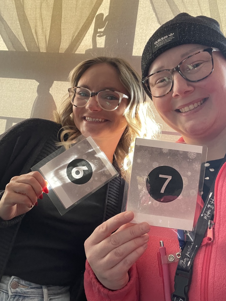 Teachers holding up their matching "6" "7" cards