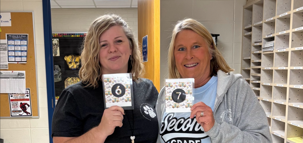 Teachers holding up their matching "6" "7" cards