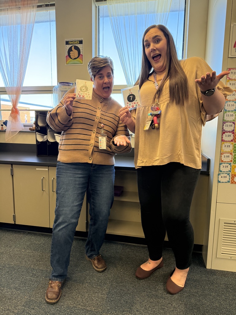 Teachers holding up their matching "6" "7" cards