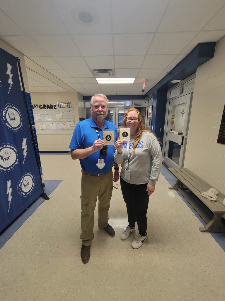 Teachers holding up their matching "6" "7" cards