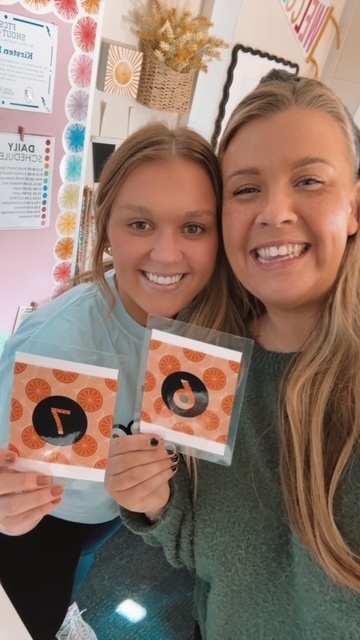 Teachers holding up their matching "6" "7" cards