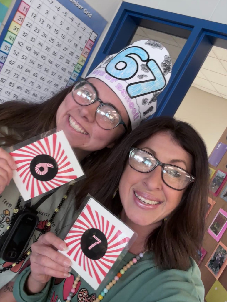 Teachers holding up their matching "6" "7" cards