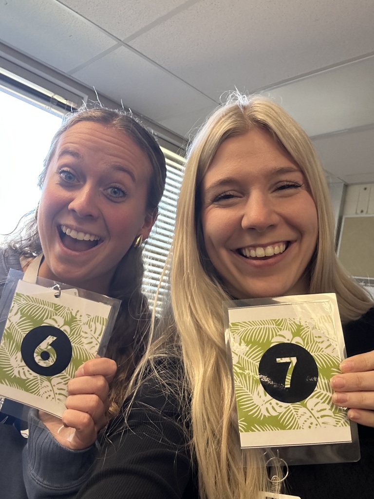 Teachers holding up their matching "6" "7" cards