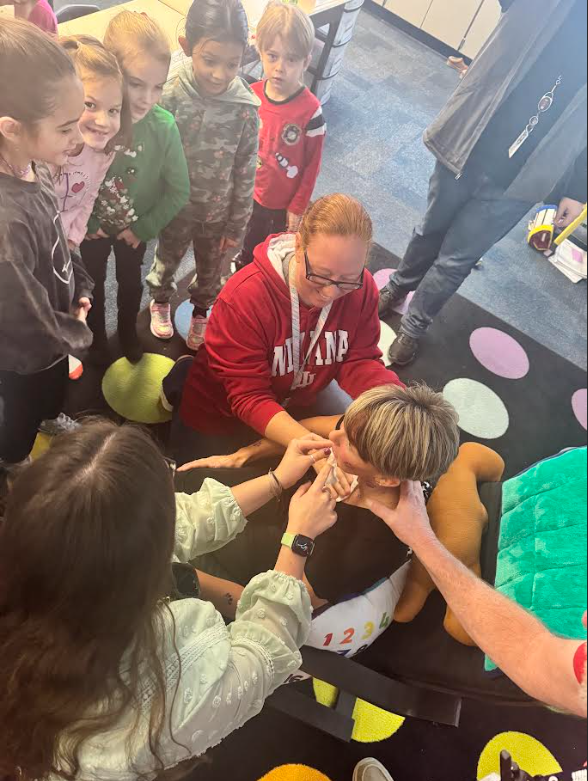 Mrs. Huff getting temporary tattoos from students