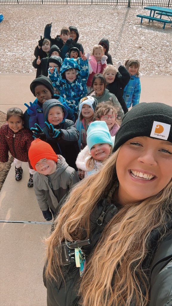 Miss Merk and her students outside smiling