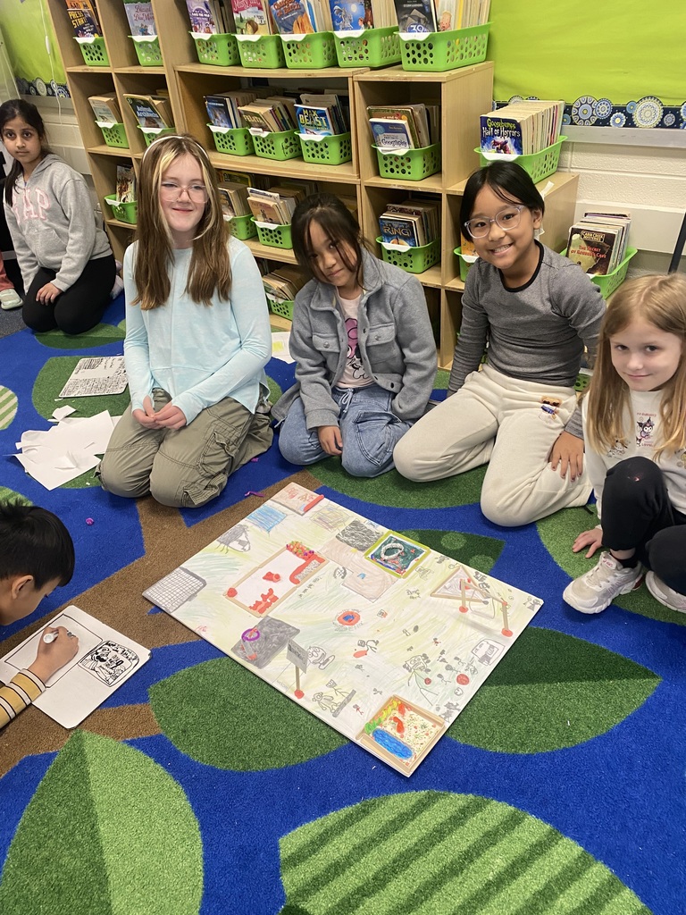 Mrs. Goodman's third grade students smiling with their playground STEM project