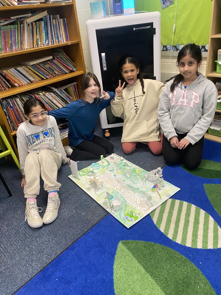 Mrs. Goodman's third grade students smiling with their playground STEM project