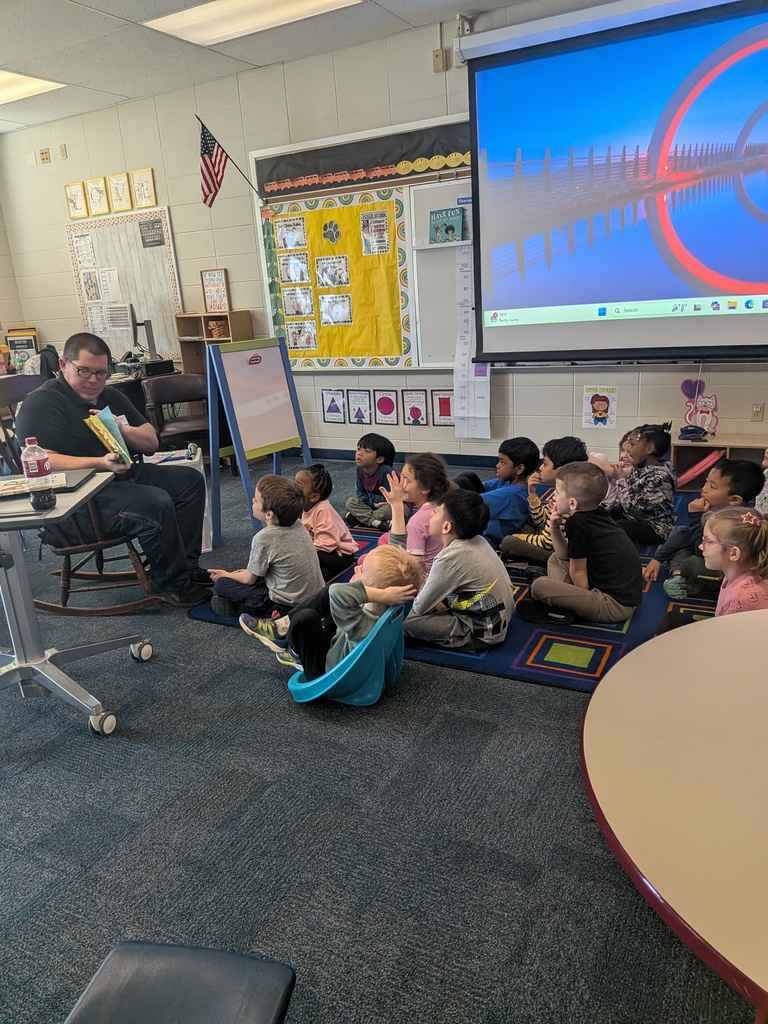 Mrs. Cowell's kindergarten class listening to a guest reader