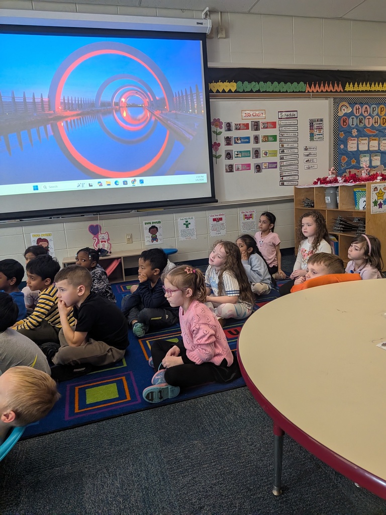 Mrs. Cowell's kindergarten class listening to a guest reader