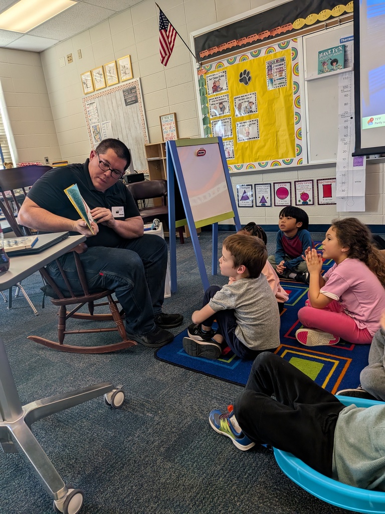 Mrs. Cowell's kindergarten class listening to a guest reader