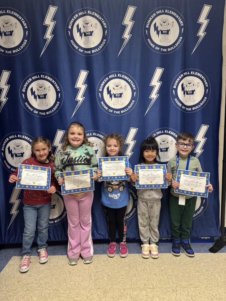 Kindergarten star students of the month holding their certificates