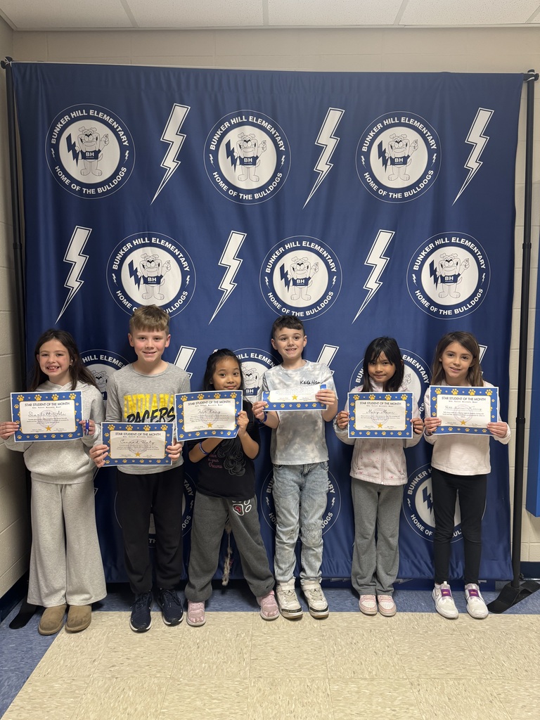 Second grade star students of the month holding their certificates