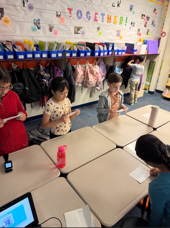 second grader holding letter of encouragement