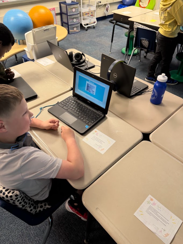 second grader holding letter of encouragement