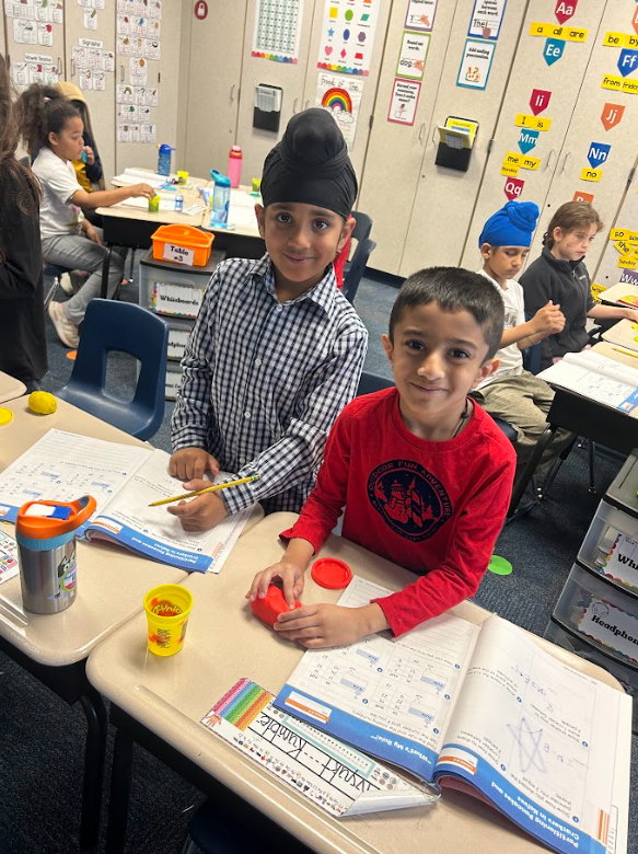 first grade students using play-doh to work on the concept of halves