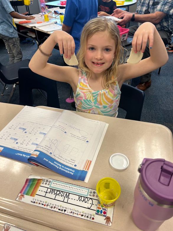 first grade students using play-doh to work on the concept of halves