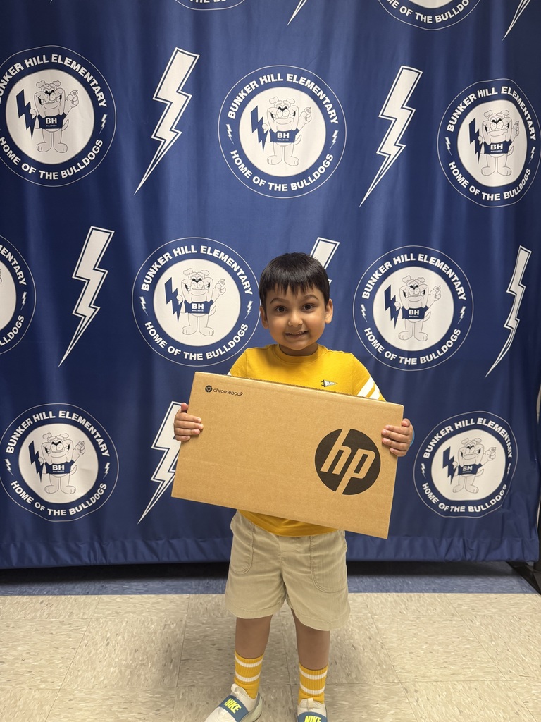 student smiling with chromebook box