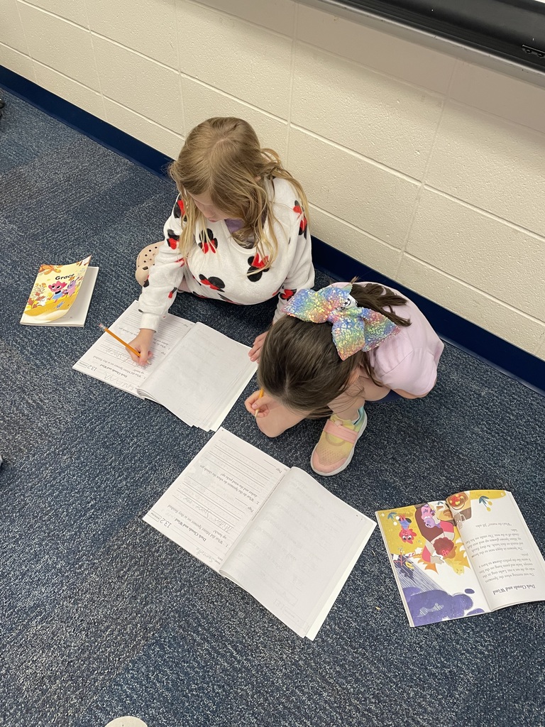 first grade students working in workbooks during class