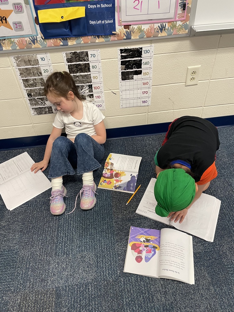 first grade students working in workbooks during class