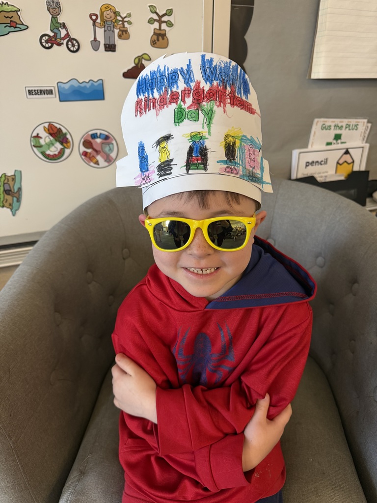 Kindergarten students wearing hats that they decorated for World Kindergarten Day