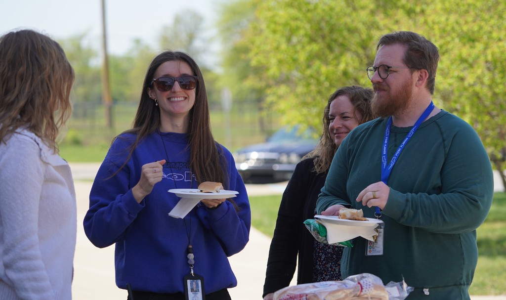 group of staff talking at junior high cookout
