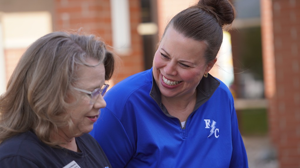 Two women talking and smiling