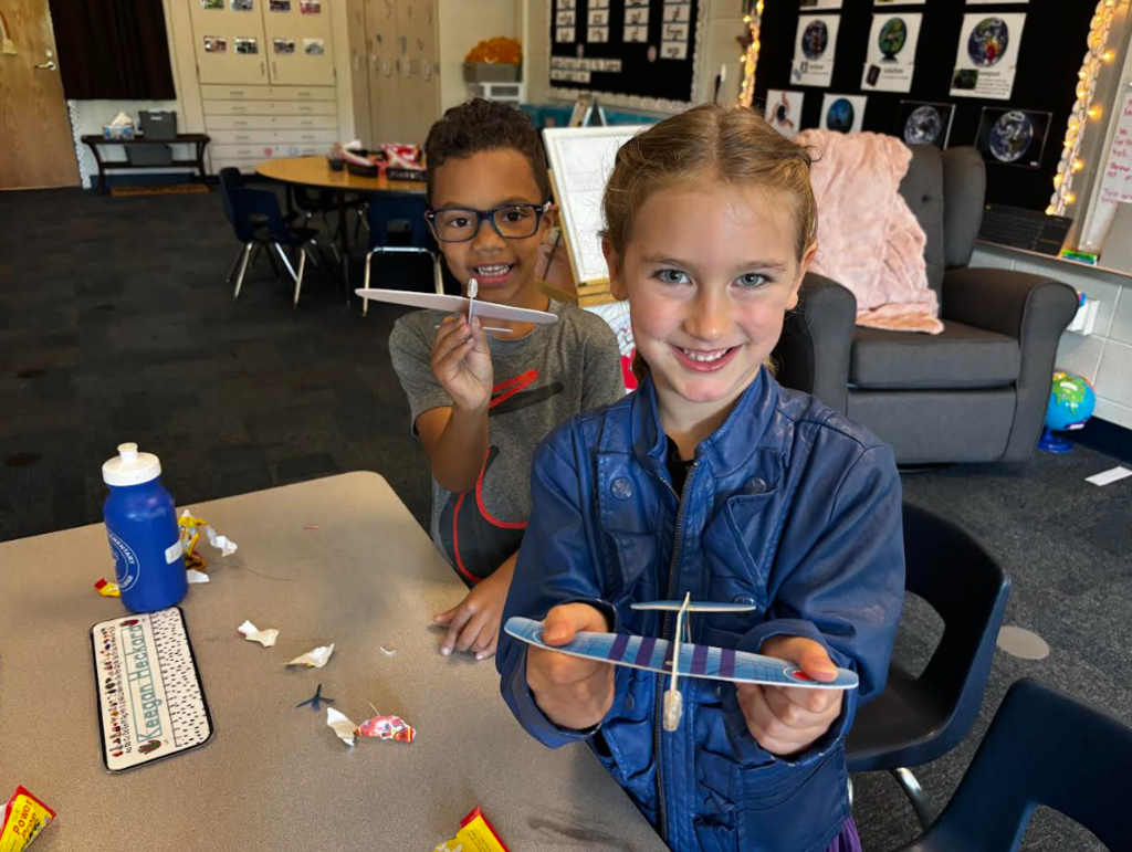 Miss Milligan's kindergarten class on A Day flying paper airplanes