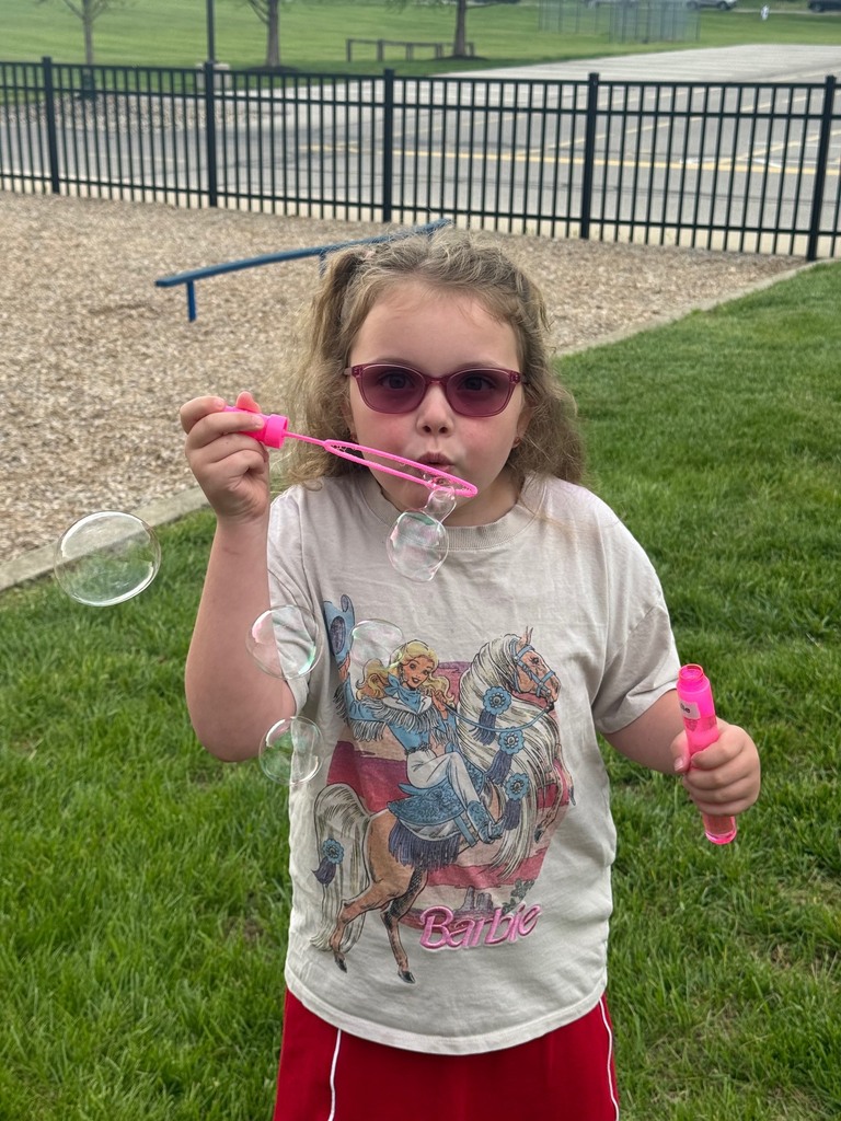 student blowing bubbles on B for Bubbles day